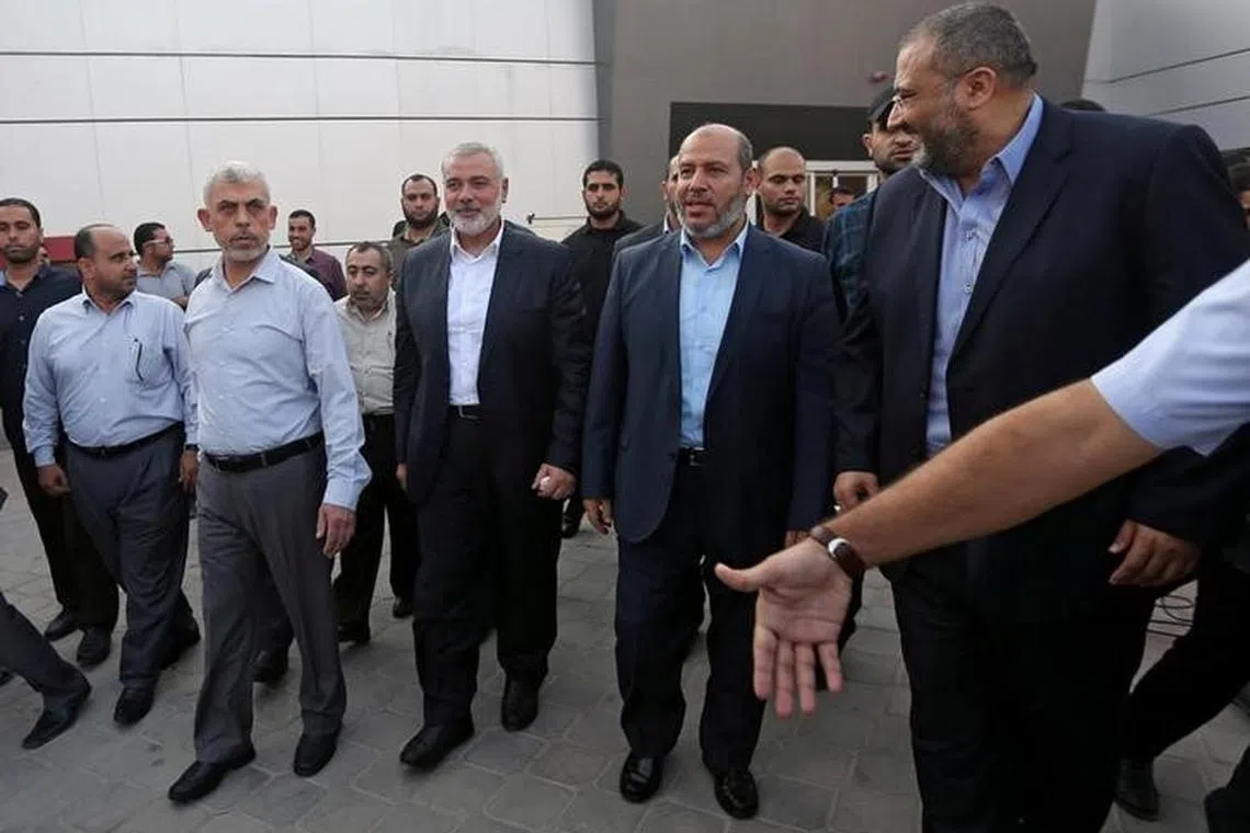 Hamas Gaza Chief Yahya Al-Sinwar, Hamas Chief Ismail Haniyeh and senior Hamas leader Khalil al-Hayya arrive at the Rafah border crossing in the southern Gaza Strip September 19, 2017. REUTERS/Ibraheem Abu Mustafa