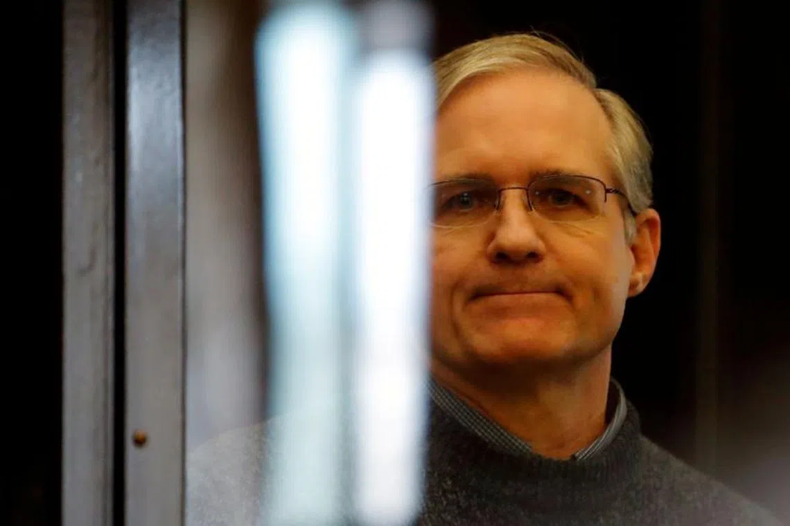FILE PHOTO: Former U.S. Marine Paul Whelan, who was detained and accused of espionage, stands inside a defendants' cage during his verdict hearing in Moscow, Russia June 15, 2020. REUTERS/Maxim Shemetov/File Photo