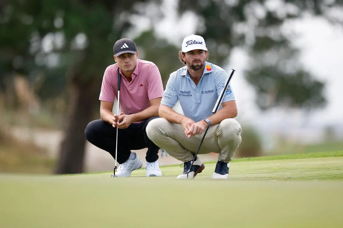 Ludvig Aberg (left) of Sweden and Cameron Young of the United States line up putts on the 16th green during the second round of The RSM Classic.