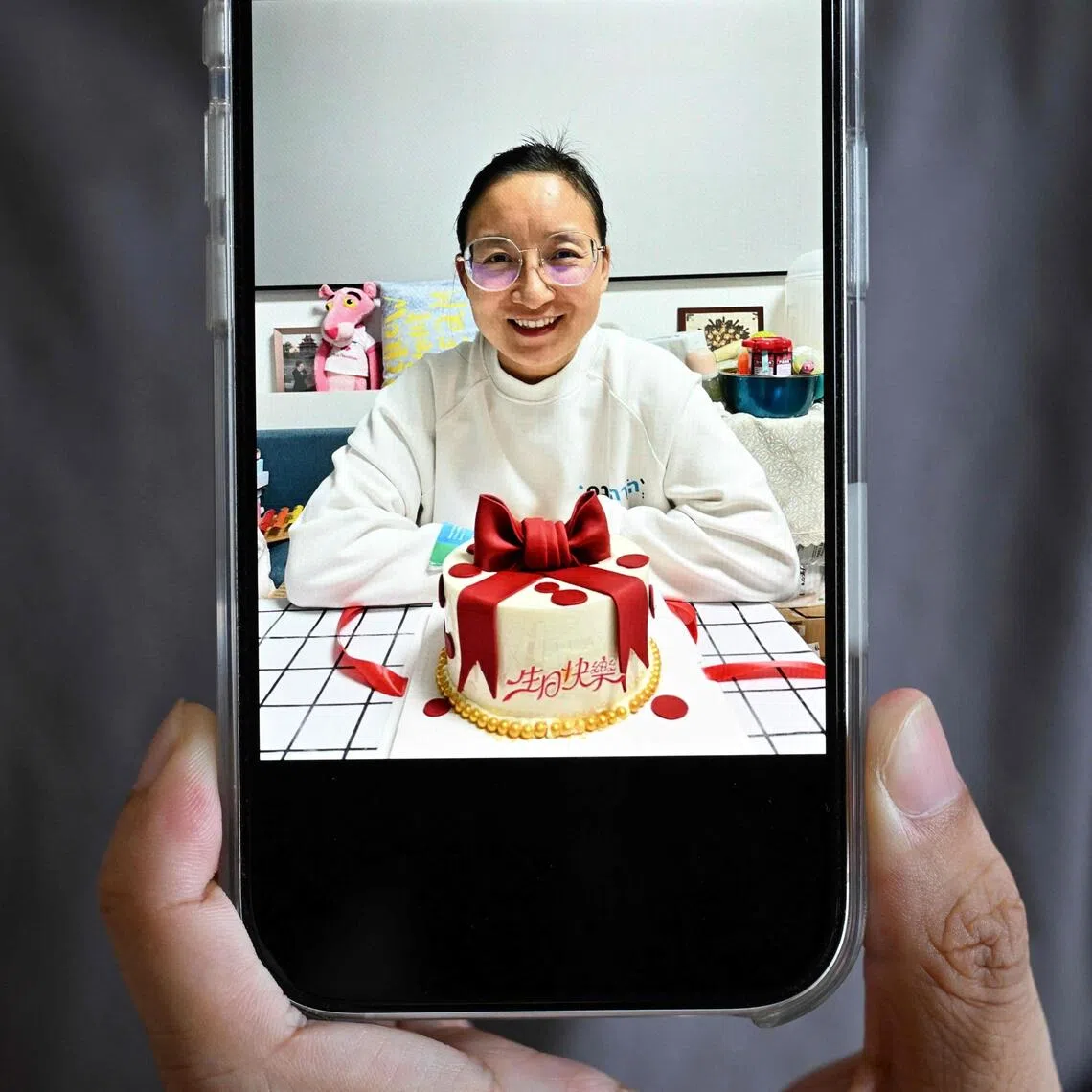 Ren Zhong shows a picture of his detained wife Wang Cong, a pastor at Zion Church, during an interview at his house in Beihai on July 29.