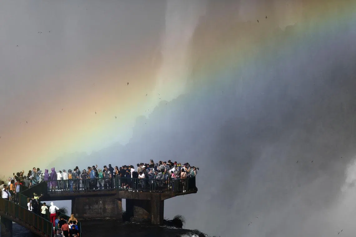 Tourists enjoying the Iguazu Falls from an observation platform at the Iguazu National Park near the southern Brazilian city of Foz do Iguacu, in Brazil, July 2.