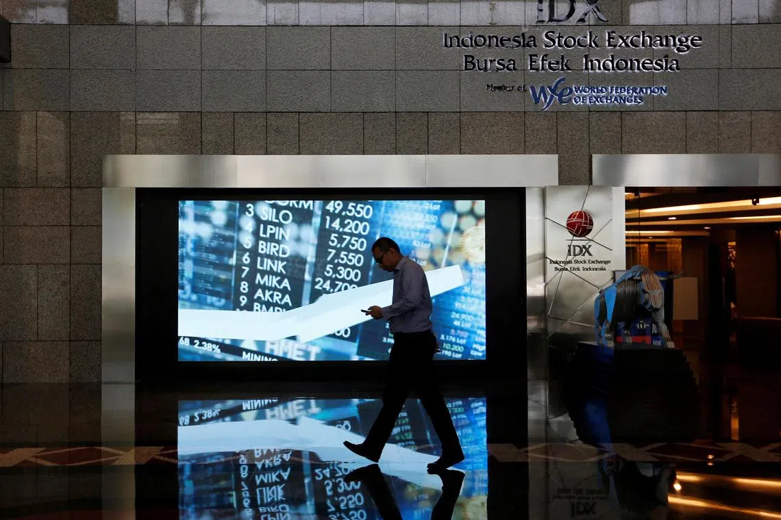 A man walks past screen at the Indonesia Stock Exchange building in Jakarta, Indonesia, September 6, 2018. REUTERS/Willy Kurniawan/File Photo