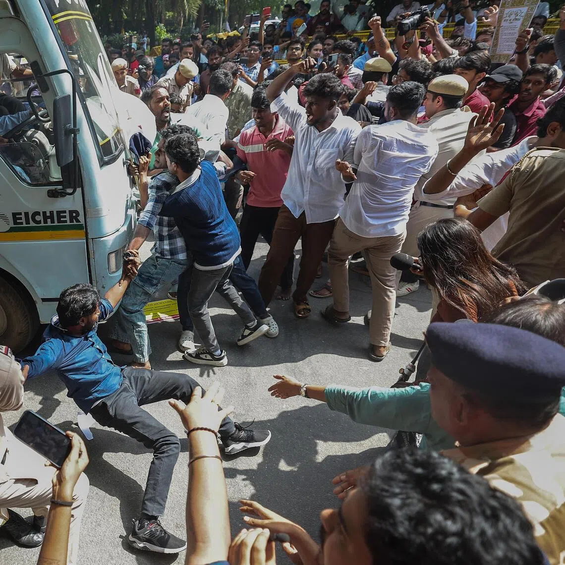 Indian activists trying to stop a bus carrying detained social activists and student activists from Left parties during a protest demanding the resignation of Chief Election Commissioner Gyanesh Kumar near Jantar Mantar in New Delhi, India, on Oct 2.