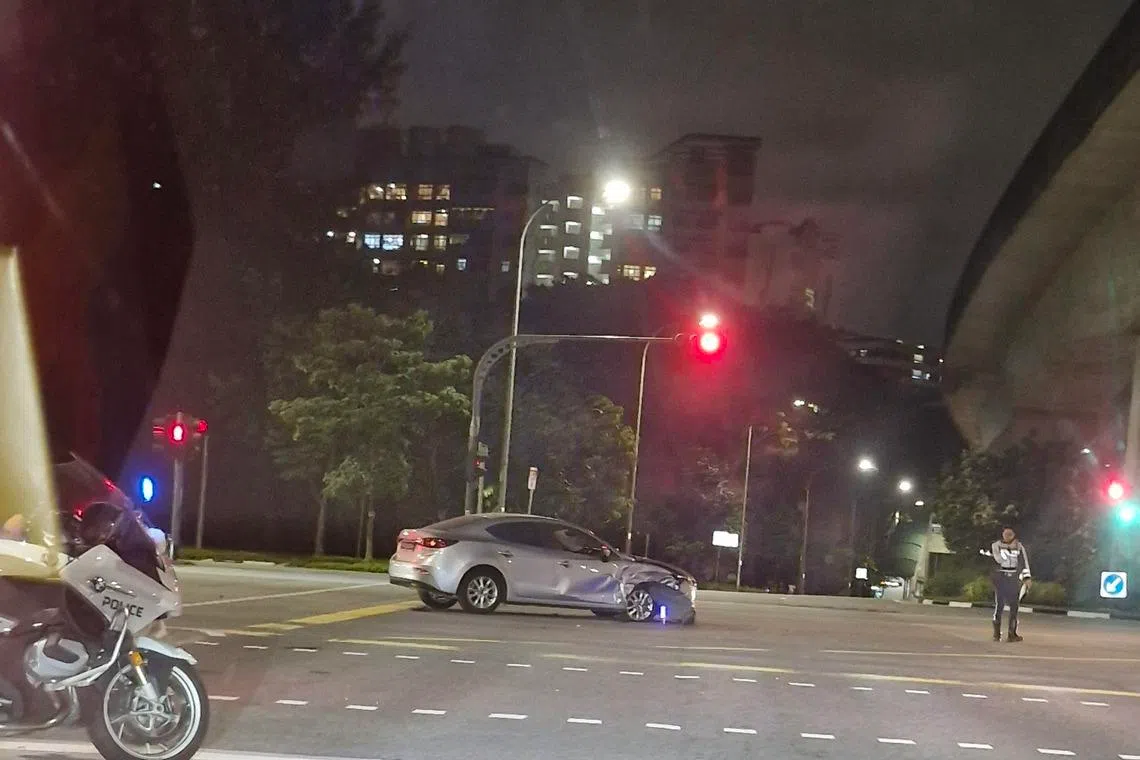 A visibly dmaaged silver sedan after an accident in Punggol on Jan 23.