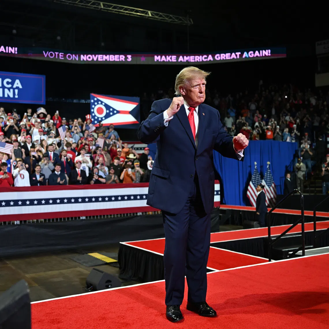 President Donald Trump on stage at a rally, where protester Blake Miley revealed a T-shirt with the message, “Release the Epstein Files,” on Oct 12 in Youngstown, Ohio.