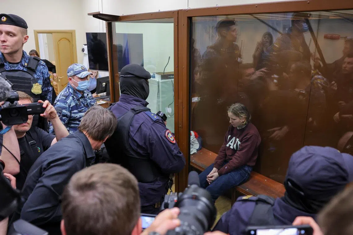 Darya Trepova sits in an enclosure for defendants during a court hearing in Moscow.
