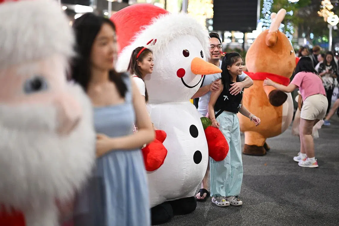 ST20241224_202430800741-Lim Yaohui-pixchristmas24/ Revellers taking photos with Christmas mascots Santa Claus, Snowman and Reindeer during the Great Christmas Eve Street Party at Orchard Road on Dec 24, 2024. The much-anticipated Great Christmas Eve Street Party is making a triumphant return, stretching 400m from ION Orchard to Ngee Ann City. It will feature live DJ performances, roving mascots, pop-up stalls, food trucks, as well as a countdown to Christmas, among other offerings. A section of Orchard Road from Paterson Road junction to Bideford Road junction will be closed to vehicular traffic on 24 December 2024 from 6pm to 2am for revellers as the countdown to Christmas Day begins at 8pm. (ST PHOTO: LIM YAOHUI)