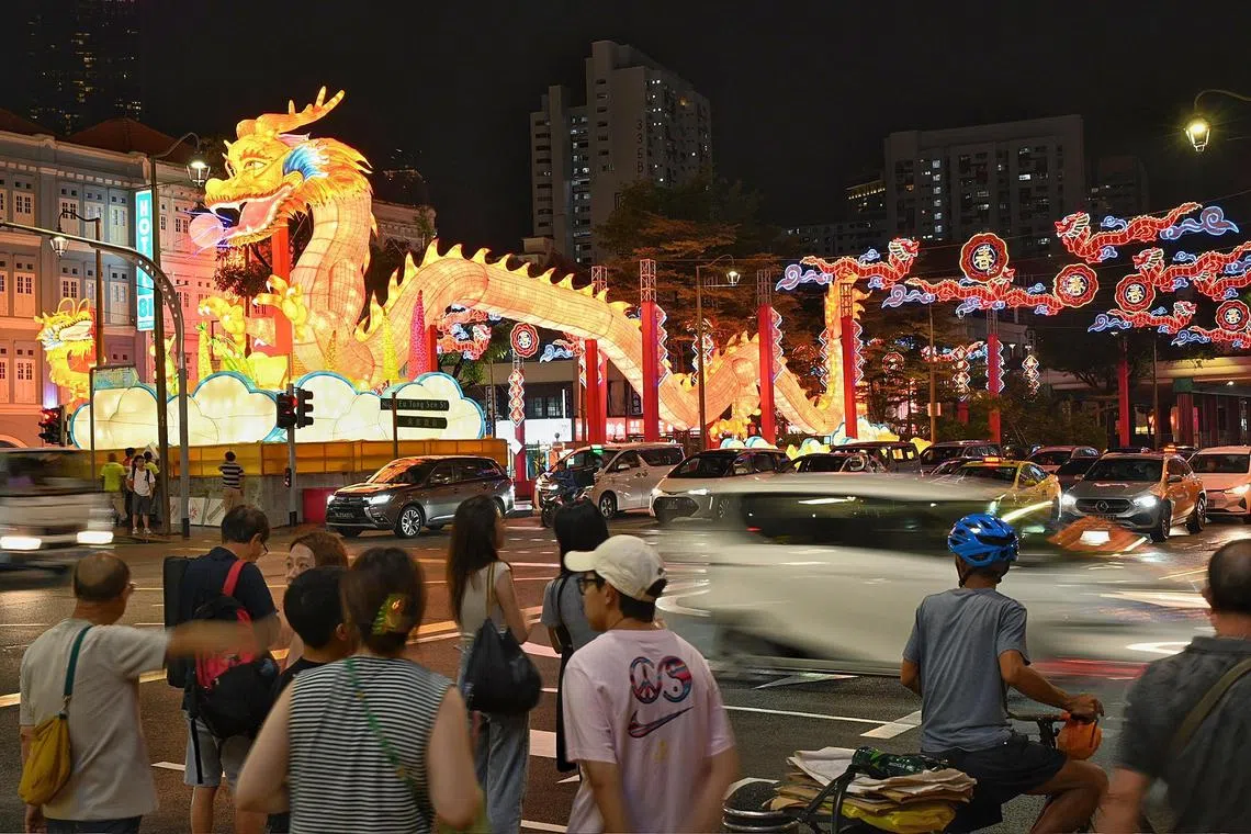 Visitors watching the light up of the Chinatown dragon on Jan 19.