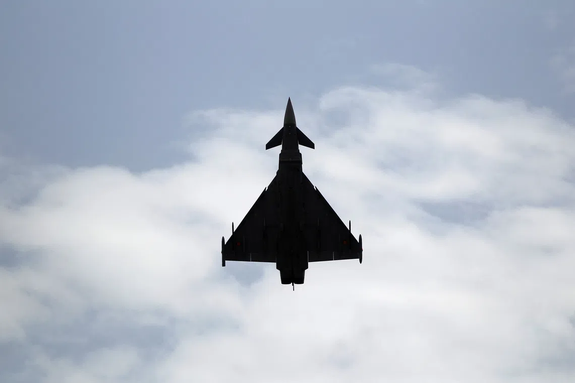 A Eurofighter Typhoon fighter jet flies vertically over a beach during an airshow in Torre del Mar, southern Spain, July 31, 2016. REUTERS/Jon Nazca