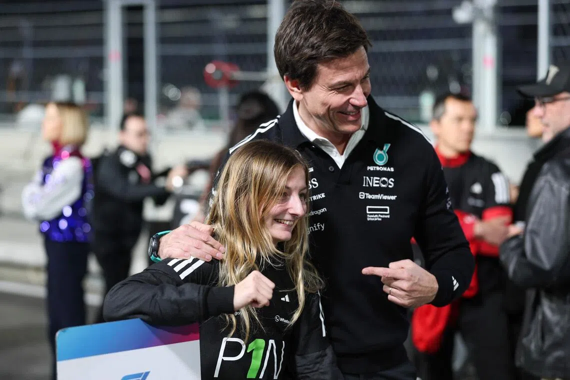 French driver Doriane Pin celebrates her 2025 F1 Academy drivers' championship victory with Mercedes' Austrian team principal and CEO Toto Wolff after the F1 Academy race at the Las Vegas Strip Circuit in Nevada, on Nov 22, 2025.