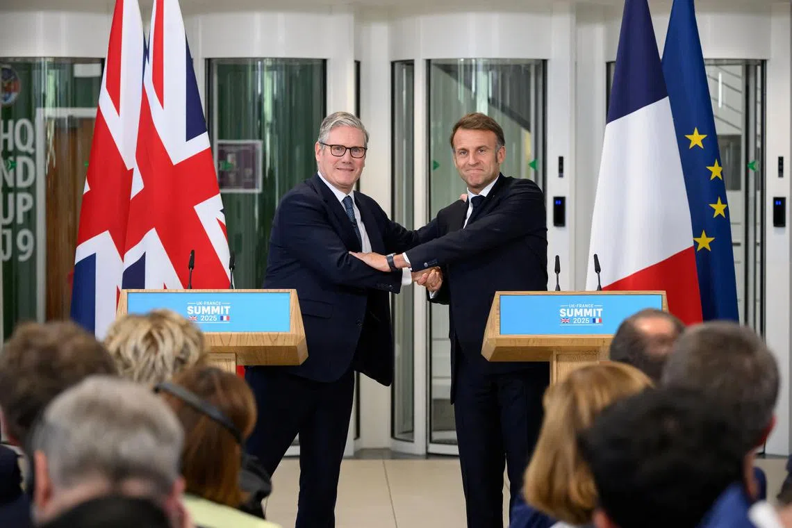 UK Prime Minister Keir Starmer (left) and French President Emmanuel Macron shaking hands at a press conference in London on July 10.