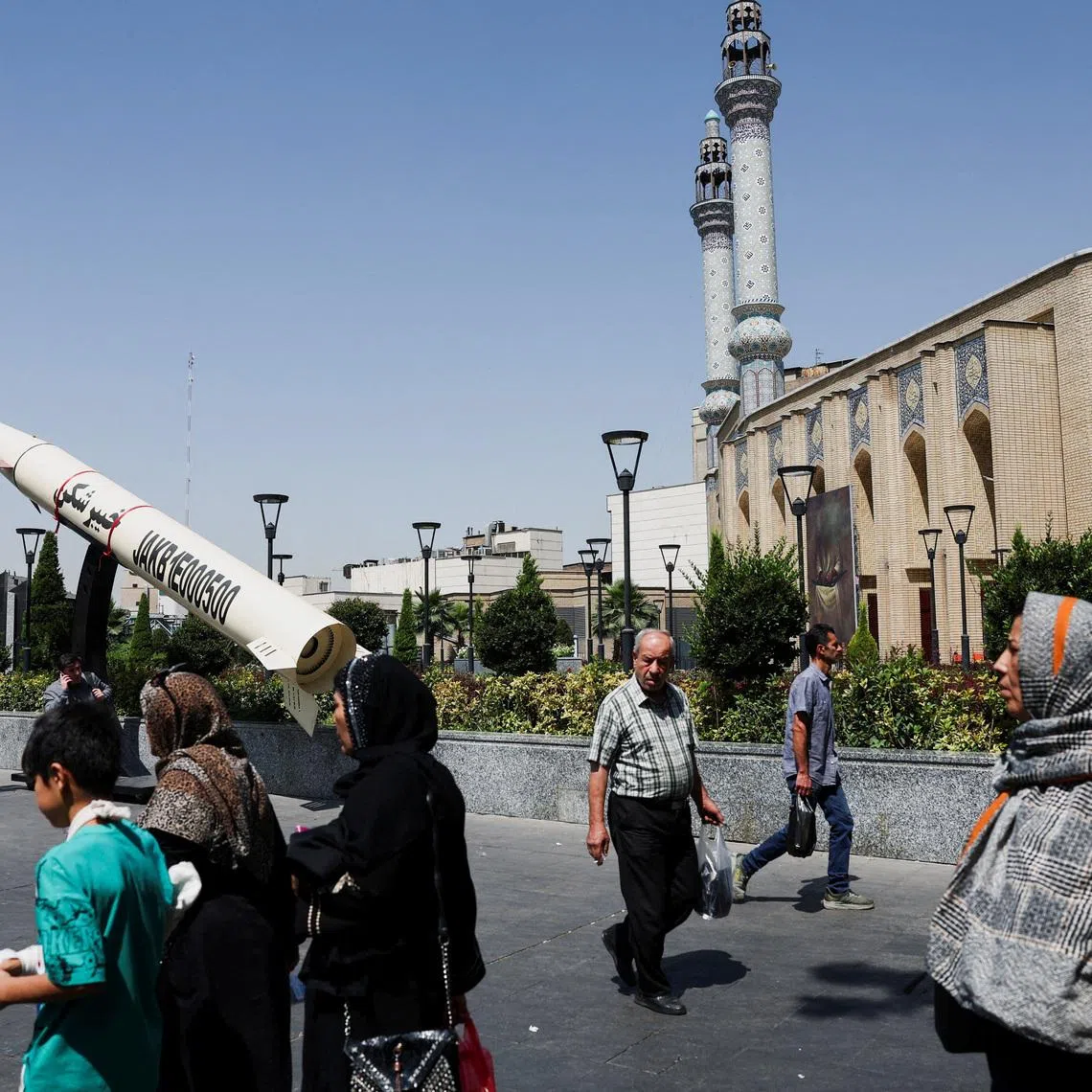 People walk next to a symbolic mock-up of an Iranian missile, on a street in Tehran, Iran, June 11, 2026. Majid Asgaripour/WANA (West Asia News Agency) via REUTERS