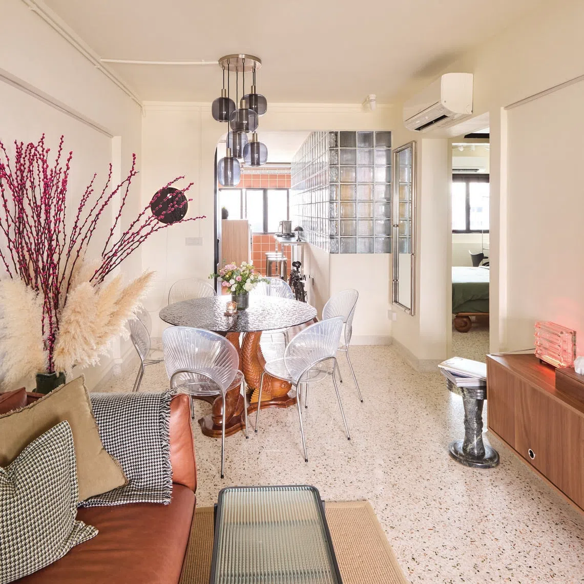 Wood, glass and terrazzo come together to create a cosy mix of textures in this HDB flat.