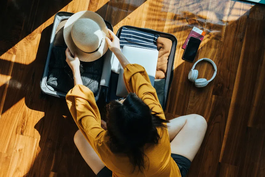 Woman packing luggage for holiday
