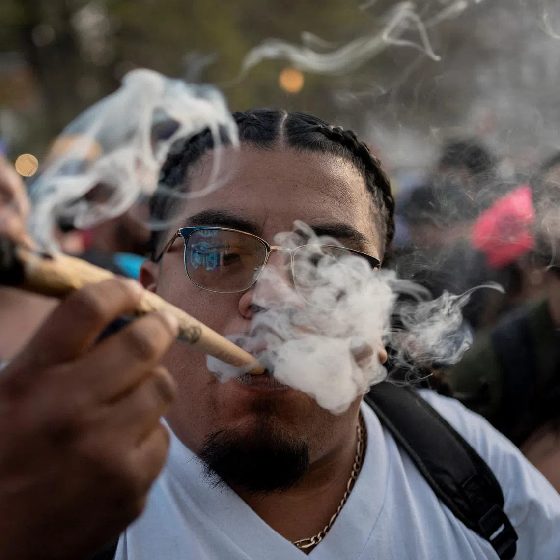 A reveller smokes cannabis at the Mile High 420 Festival in Denver, Colorado, U.S., April 20, 2026.  REUTERS/Cheney Orr