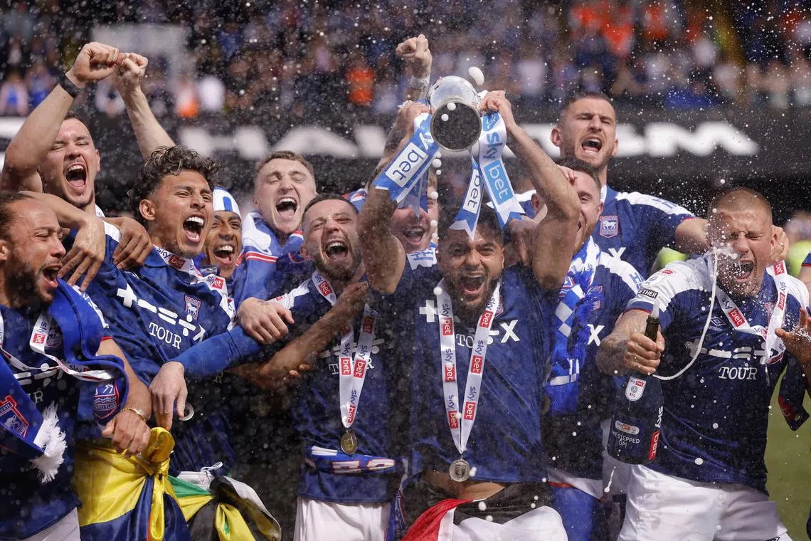 Soccer Football - Championship - Ipswich Town v Huddersfield Town - Portman Road, Ipswich, Britain - May 4, 2024
Ipswich Town players celebrate with a trophy and promotion to the Premier League Action Images via Reuters/Andrew Couldridge NO USE WITH UNAUTHORIZED AUDIO, VIDEO, DATA, FIXTURE LISTS, CLUB/LEAGUE LOGOS OR 'LIVE' SERVICES. ONLINE IN-MATCH USE LIMITED TO 45 IMAGES, NO VIDEO EMULATION. NO USE IN BETTING, GAMES OR SINGLE CLUB/LEAGUE/PLAYER PUBLICATIONS.