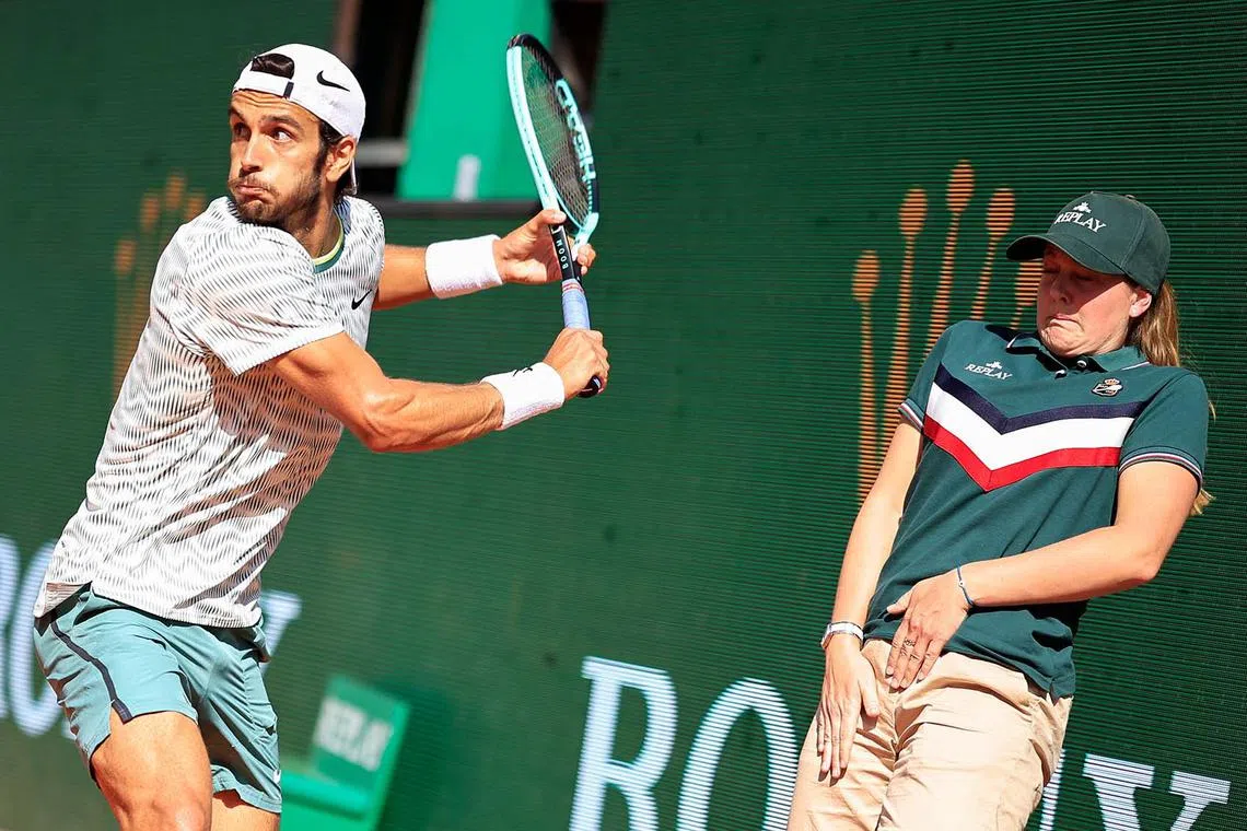 Italy's Lorenzo Musetti (left) playing a backhand return to Serbia's Novak Djokovic during their Monte Carlo ATP Masters Series Tournament round of 16 tennis match at the Monte Carlo Country Club on April 11, 2024.