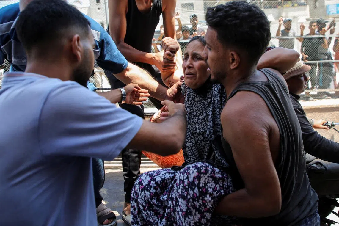 A Palestinian woman wounded in an Israeli strike is rushed into hospital following an Israeli strike, in the southern Gaza Strip on July 16.