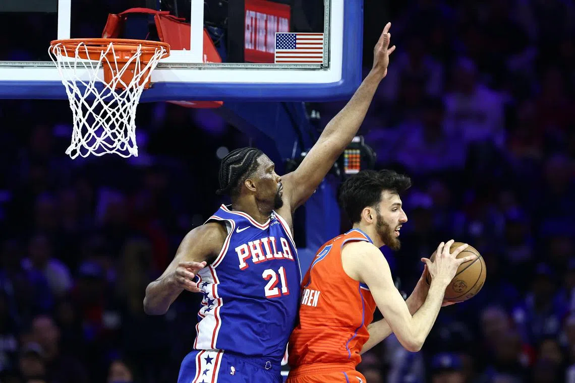 Joel Embiid of the Philadelphia 76ers guarding Chet Holmgren of the Oklahoma City Thunder during the third quarter of the Sixers' 109-105 victory at the Wells Fargo Centre on April 2. Embiid finished with 24 points, seven assists and six rebounds in his first game since suffering a knee injury in a defeat by the Golden State Warriors on Jan 30.
