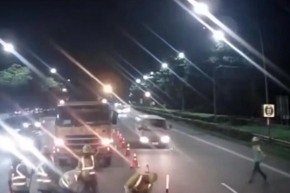 Footage shared on Facebook shows the worker making a dash from the left-most lane towards the construction site in the centre lane of the expressway.