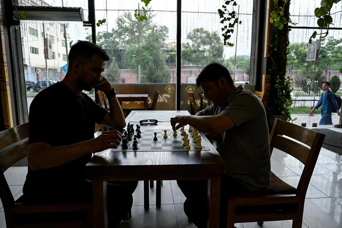 Men play chess at a cafe in Kabul on May 11.