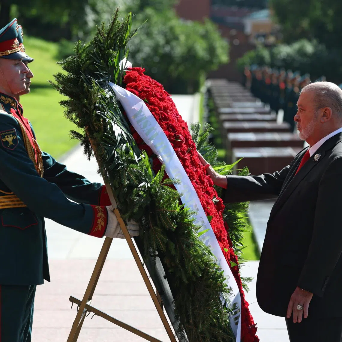 Malaysia's King Sultan Ibrahim  Iskandar (right) takes part in a wreath-laying ceremony at the Tomb of the Unknown Soldier in Moscow, Russia.