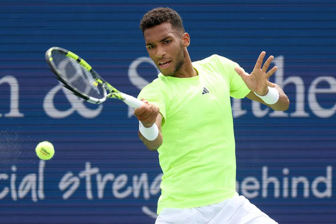 Canada's Auger-Aliassime (pictured) returning a shot to Matteo Berrettini of Italy during the Cincinnati Open.