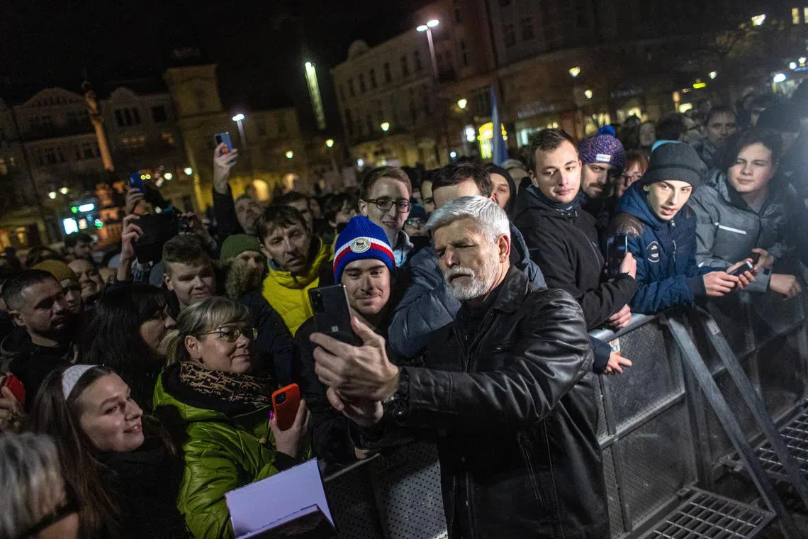 Czech presidential candidate Petr Pavel takes a selfie with supporters at a campaign event in Ostrava, Czech Republic, on Jan 19, 2023.