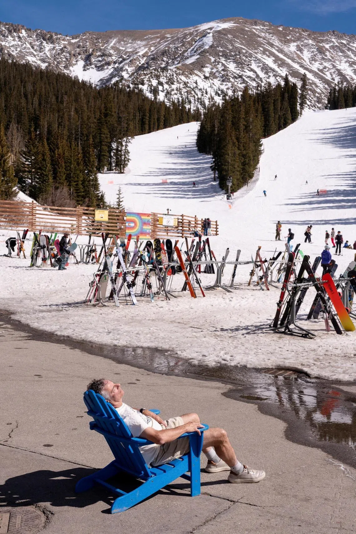 A man relaxes in the sun at Arapahoe Basin Ski Resort during a heatwave in Keystone, Colorado, US, March 21.