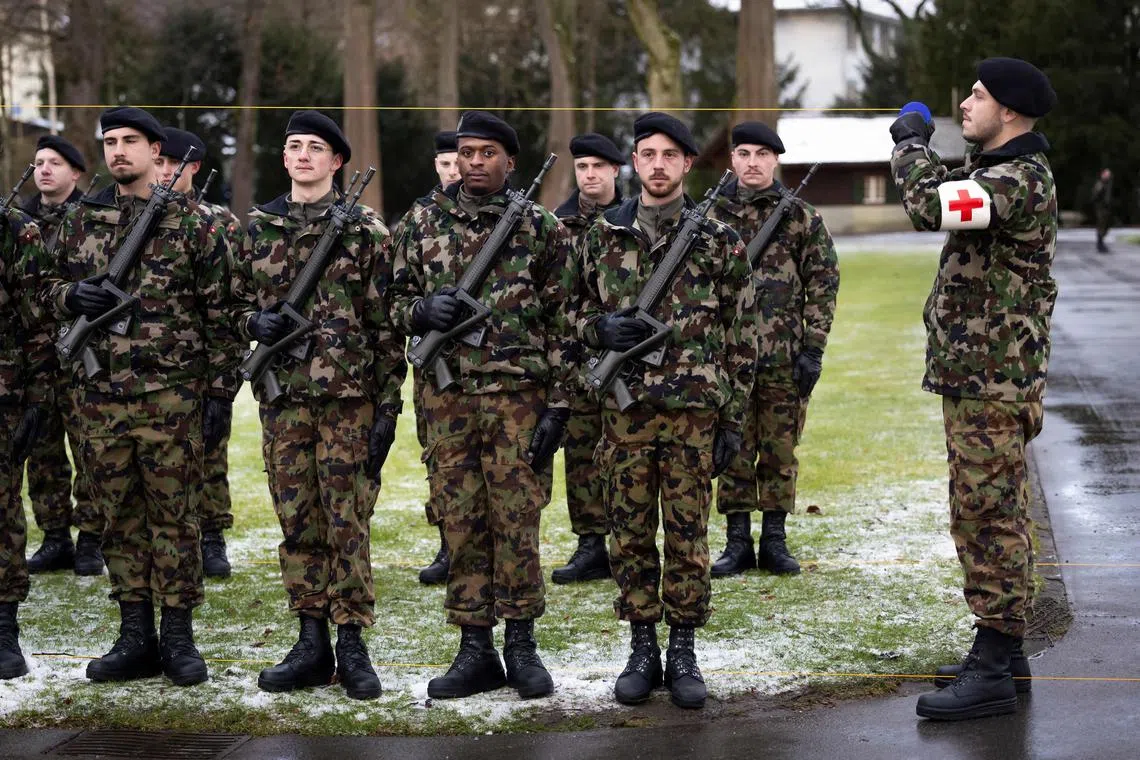 Soldiers of the Swiss army line up for the ceremony prior to the arrival of Chinese Premier and Swiss President, during an official visit in Kehrsatz, near Bern on January 15, 2024. China's Prime Minister is visiting Switzerland to attend the World Economic Forum (WEF) in Davos. (Photo by PETER KLAUNZER / POOL / AFP)