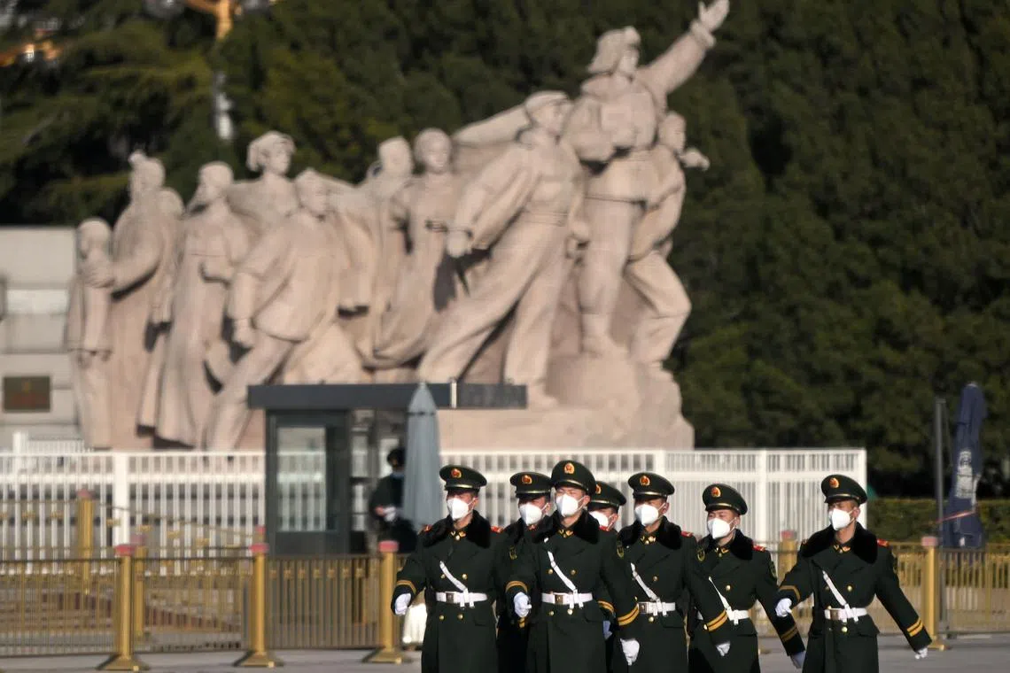 Security personnel march in the vicinity of Tiananmen Square in Beijing on March 2, 2023.