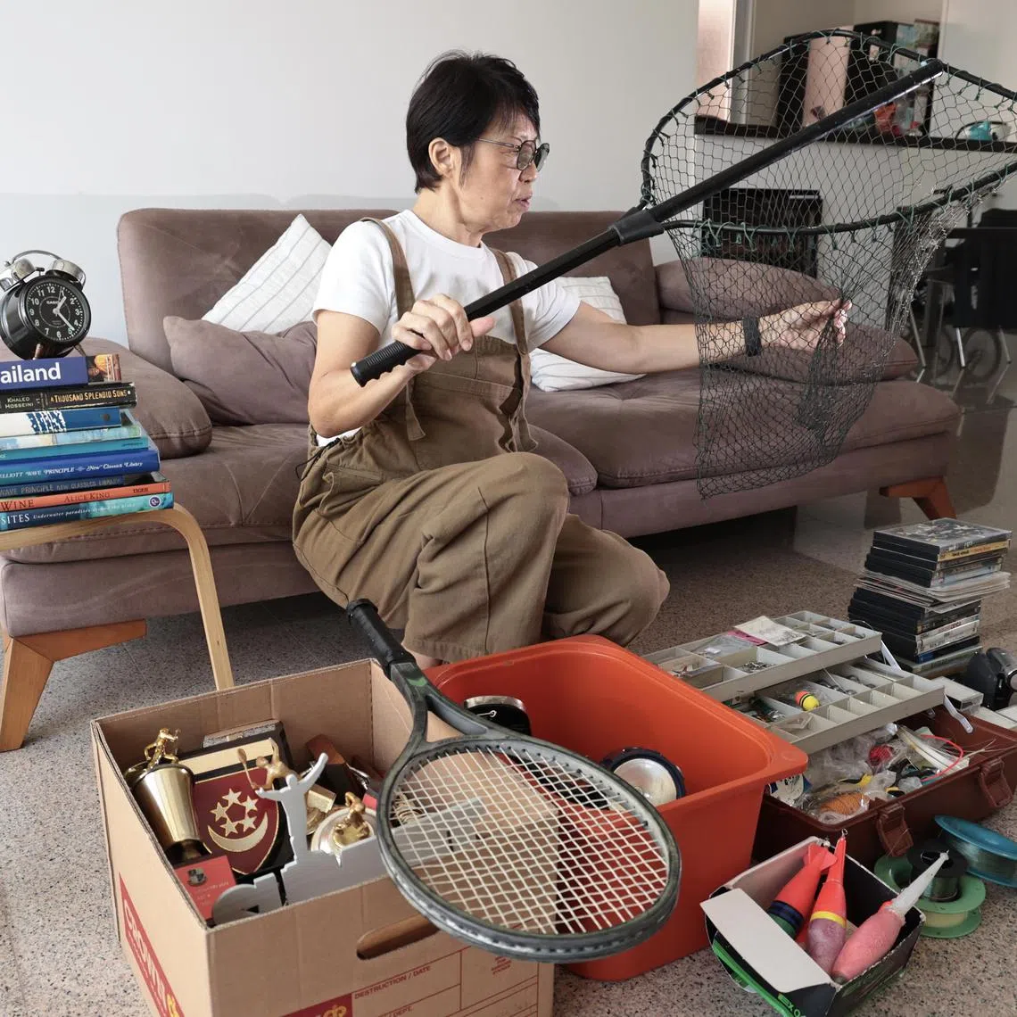Ms Margaret Ong, 61 , keeps an old fishing net her husband bought for her decades ago, even though she no longer uses it. It is hard to let go of items with sentimental associations, she says.