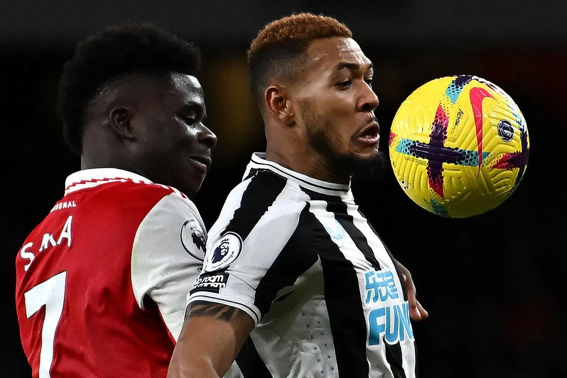 Arsenal's English midfielder Bukayo Saka (left) vies with Newcastle United's Brazilian striker Joelinton.