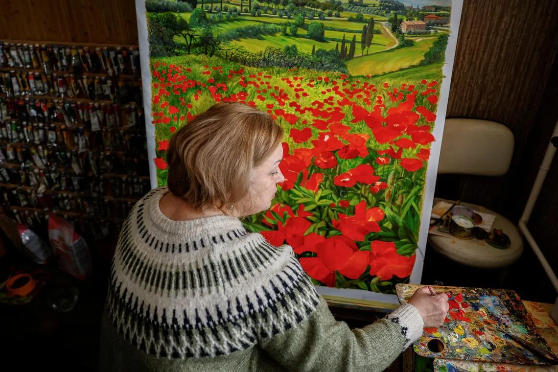 Iryna Prots, 52, artist who designed the Ukrainian skeleton racer Vladyslav Heraskevych helmet, which he wears as a tribute to athletes who were killed amid Russia's attack on Ukraine, works in her appartment in Kyiv, Ukraine, February 11, 2026. REUTERS/Alina Smutko