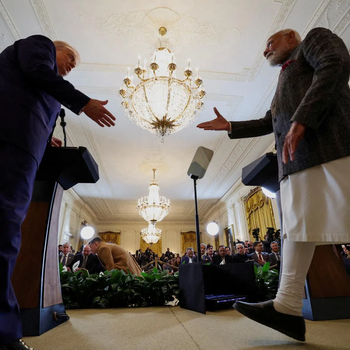 FILE PHOTO: U.S. President Donald Trump and Indian Prime Minister Narendra Modi prepare to shake hands as they attend a joint press conference at the White House in Washington, D.C., U.S., February 13, 2025. REUTERS/Kevin Lamarque/File Photo