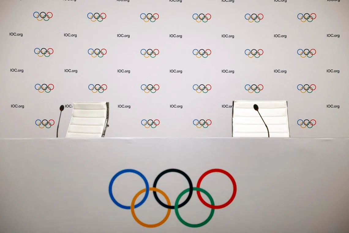 Olympics - IOC Executive Board meeting - Salon Hoche, Paris, France - November 29, 2023 The Olympic logo is seen with microphones and empty seats before a press conference REUTERS/Sarah Meyssonnier