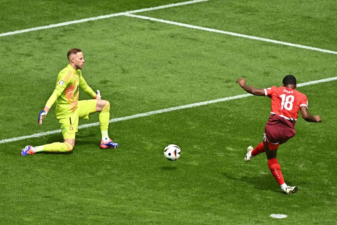 Switzerland forward Kwadwo Duah scores his team's first goal against Hungary goalkeeper Peter Gulacsi in their Euro 2024 Group A clash. 