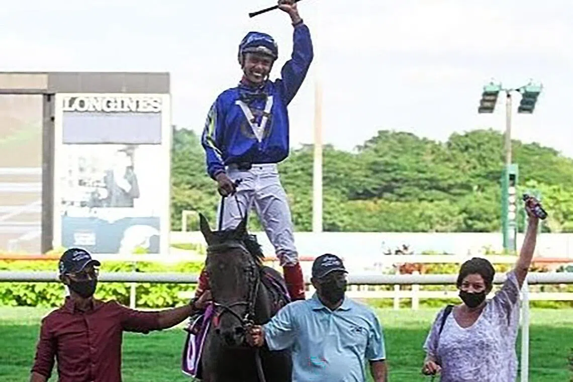 Jockey A'Isisuhairi Kasim celebrating his Group 1 Kranji Mile win on Minister with trainer Donna Logan at Kranji on May 22, 2021.

