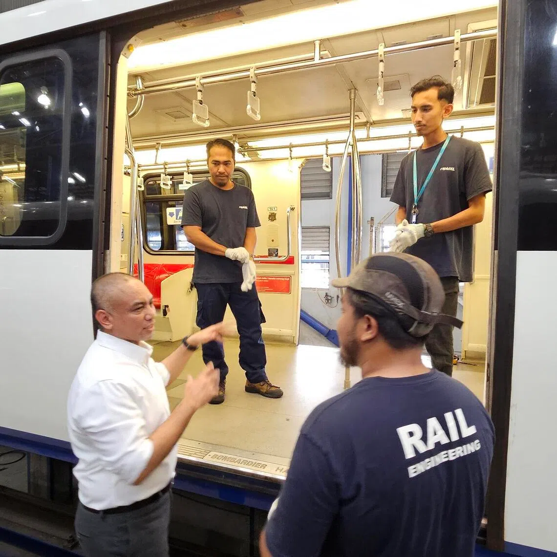 Prasarana CEO Amir Hamdan (in white shirt), discusses the Kelana Jaya LRT maintenance with his team.