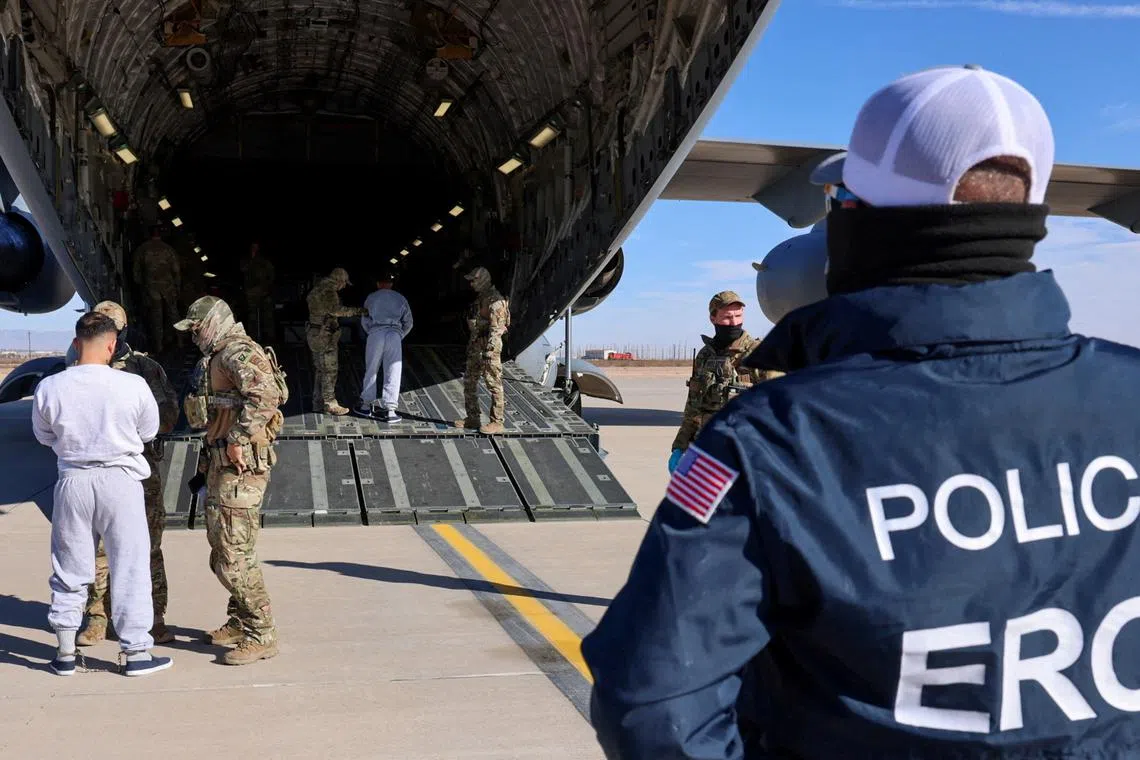 FILE PHOTO: The first U.S. military aircraft to carry detained migrants to a detention facility at Guantanamo Bay, who U.S. Department of Homeland Security spokesperson Tricia McLaughlin called \"highly dangerous criminal aliens\", is boarded from an unspecified location in the U.S. February 4, 2025  DHS/Handout via REUTERS/File Photo