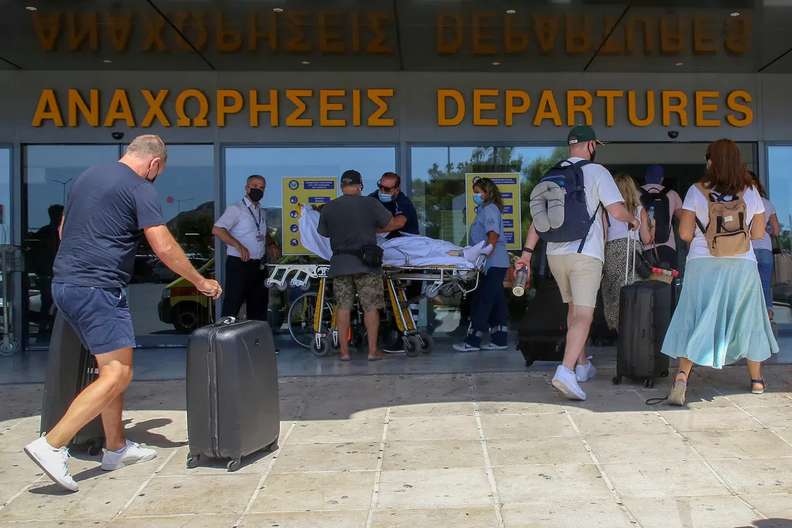 Tourists enter the departures lounge of the airport of Heraklion, on the island of Crete, Greece, September 8, 2020. REUTERS/Stefanos Rapanis/File Photo