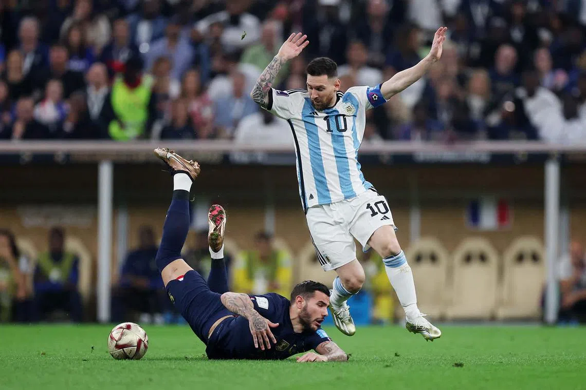 Argentina's Lionel Messi in action against France's Theo Hernandez during the FIFA World Cup Qatar 2022 finals match at Lusail Stadium in Qatar, Dec 18, 2022.