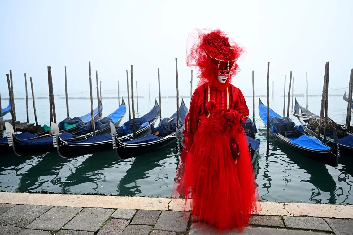 A masked reveller wearing a period costume posing during the carnival in Venice on Jan 28, 2024.