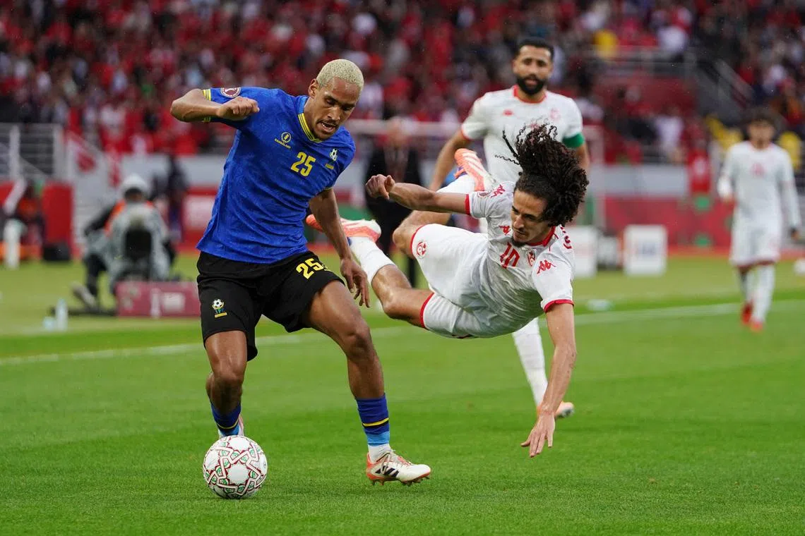 Soccer Football - CAF Africa Cup of Nations - Morocco 2025 - Group C - Tanzania v Tunisia - Prince Moulay Abdellah Stadium, Rabat, Morocco - December 30, 2025 Tunisia's Hannibal Mejbri in action with Tanzania's Haji Mnoga REUTERS/Stringer