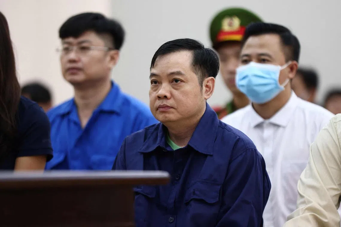 Karaoke bar owner Le Anh Xuan (centre) was given eight years in jail.