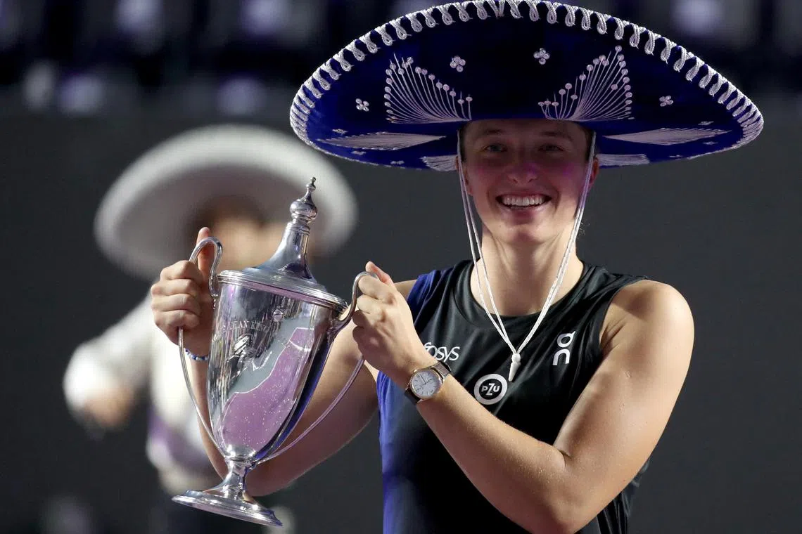 Poland's Iga Swiatek celebrating with the trophy after winning her WTA Finals against Jessica Pegula.