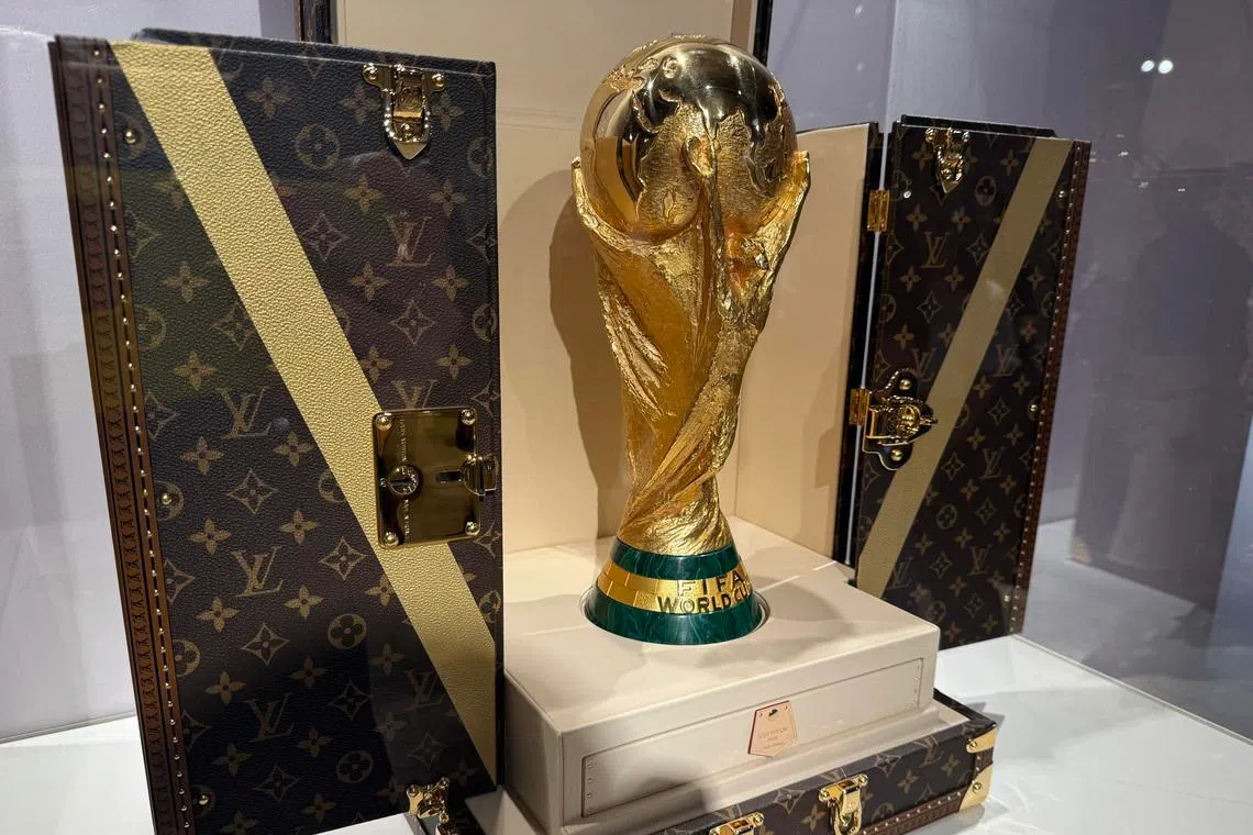 A World Cup replica trophy is displayed in a Louis Vuitton trophy trunk in a store in New York City.