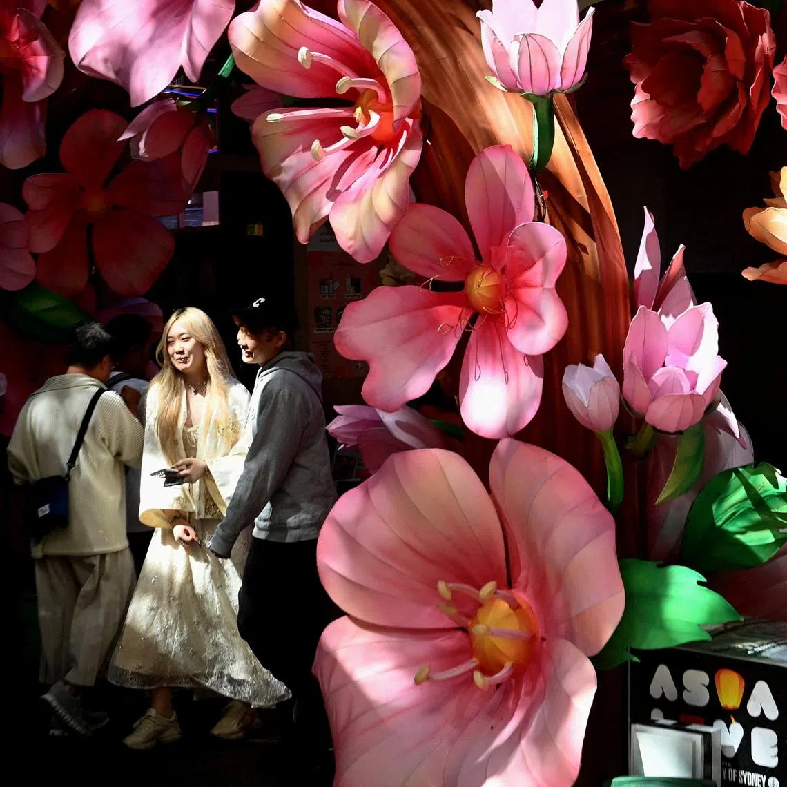 Visitors walking through an art installation in Chinatown in Sydney, Australia, on April 7, 2026. 