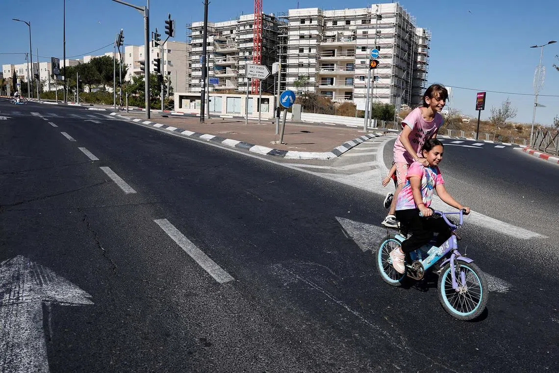 Girls riding a bicycle along a street during Yom Kippur, the Jewish day of atonement and the holiest day in the Jewish calendar, in Jerusalem, Sept 25.