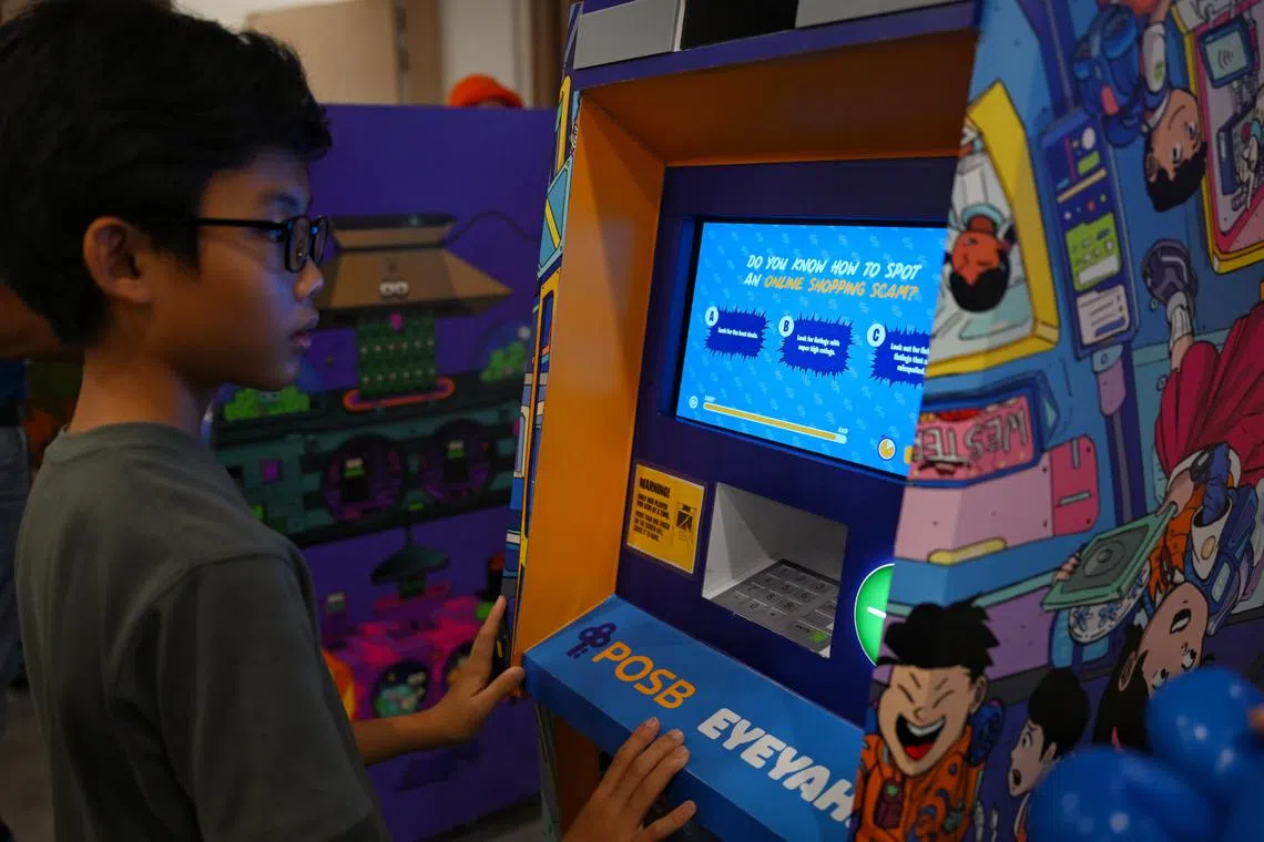 Chiong Tze Yu, 13, answering a question about online shopping scams on a ?children?s ATM? with the game KERCHINGGG! An inter-school quiz about financial wellness by EYEYAH! at the POSB Your Neighbourhood Carnival community event at the Tzu Chi Humanistic Youth Centre in Yishun on Nov 2, 2024.